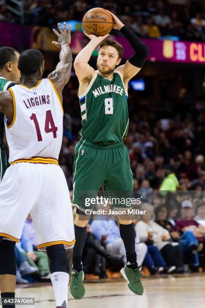 Matthew Dellavedova of the Milwaukee Bucks shoots over DeAndre Liggins of the Cleveland Cavaliers during the first half at Quicken Loans Arena on...