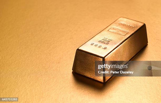 gold ingot with gold copy space - gold bars stock pictures, royalty-free photos & images