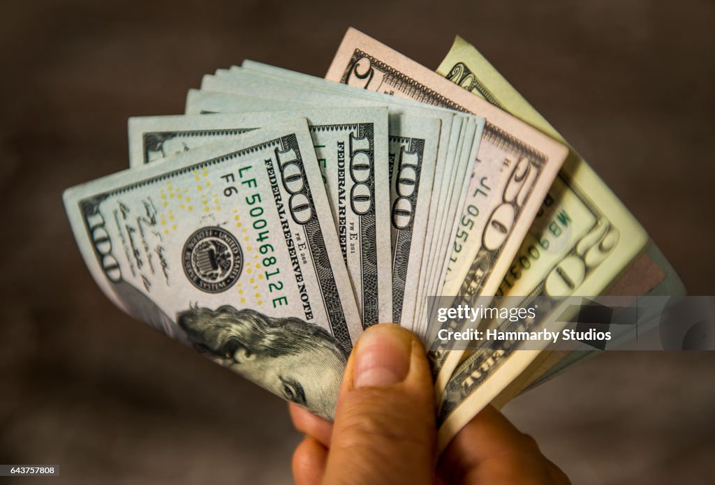 Irreconhecível homem maduro com notas de dólar dos EUA