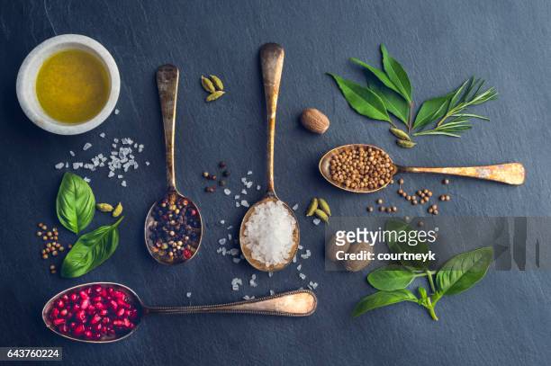 herbs and spices on slate. - food dressing stock pictures, royalty-free photos & images