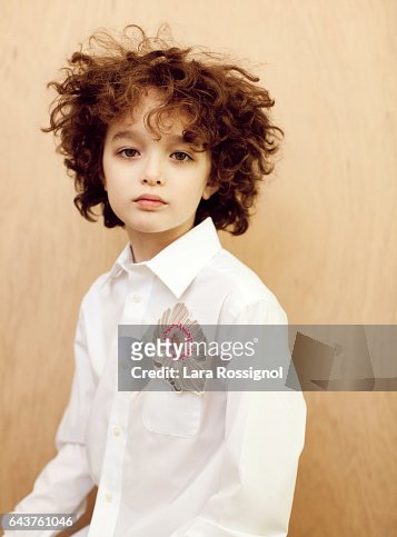 Cute Curly Haired Boy In White And Flower High-Res Stock Photo - Getty  Images