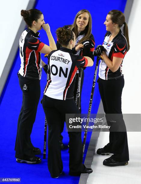 Lisa Weagle, Joanne Courtney, Rachel Homan and Emma Miskew of Ontario talk between ends in a draw eleven match against Newfoundland & Labrador during...