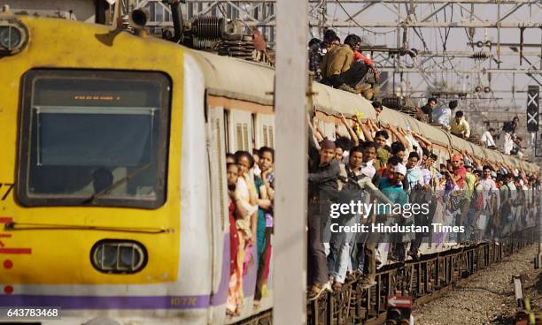 Commuters travel by local train in Mumbai on February 24, 2010 as Indian Railways Minister Kumari Mamata Banerjee presents the railway budget for the...