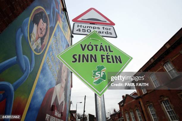 Poster for Sinn Fein is seen near a mural depicting IRA hunger striker Bobby Sands in Belfast, Northern Ireland on February 22, 2017. - Sinn Fein's...