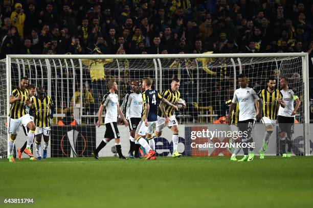Fenerbahce's Brazilian midfielder Souza celebrates with teammates after scoring a goal during the UEFA Europa League round of 32 second leg football...