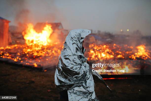 Campers set structures on fire in preparation of the Army Corp's 2pm deadline to leave the Oceti Sakowin protest camp on February 22, 2017 in Cannon...