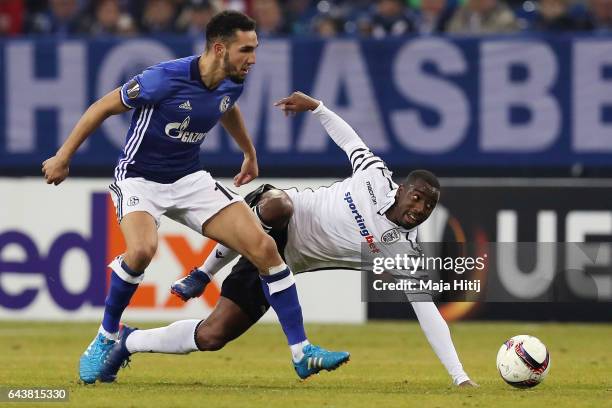 Nabil Bentaleb of Schalke is challenged by Djalma Campos of PAOK during the UEFA Europa League Round of 32 second leg match between FC Schalke 04 and...