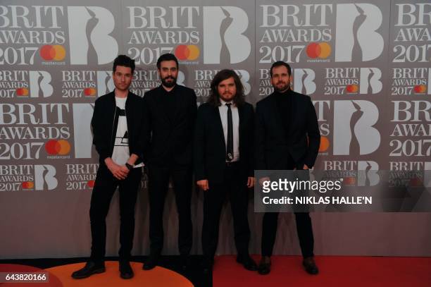 British indie pop band 'Bastille', Dan Smith, Kyle Simmons, Will Farquarson, and drummer Chris Wood pose on the red carpet arriving for the BRIT...