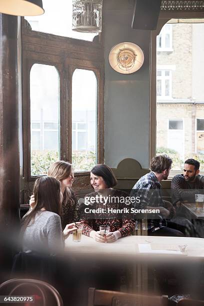 friends at a pub - london pub stock pictures, royalty-free photos & images