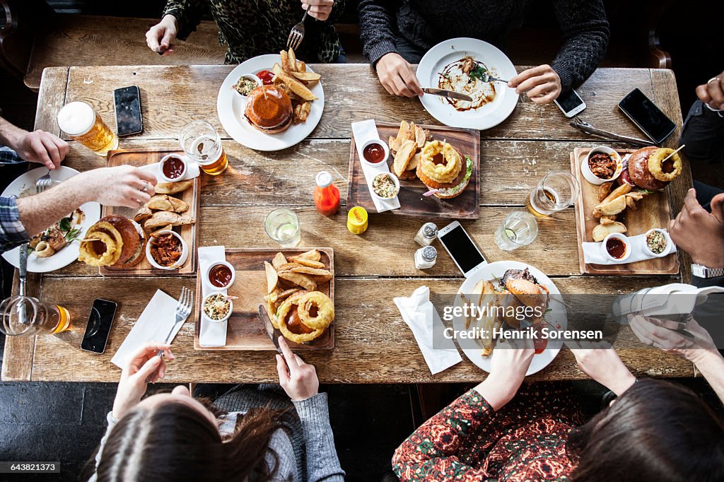 Friends at a pub eating, birds view