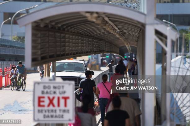 People cross the Laredo Port of Entry foot bridge on the US/Mexico border in Laredo, Texas, on February 22, 2017. Attention Editors, this image is...