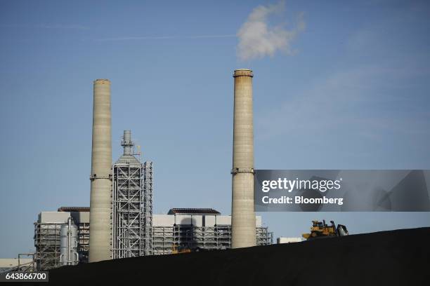 Bulldozer drives on a coal mound at the NRG Energy Inc. WA Parish generating station in Thompsons, Texas, U.S., on Thursday, Feb. 16, 2017. The plant...