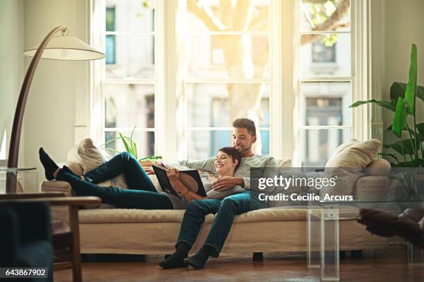 hanging out with each other - young couple reading book stock pictures, royalty-free photos & images