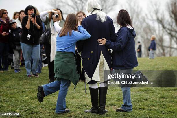 Dean Malissa portrays President George Washington as he poses for photogrpahs with vistors at the Mount Vernon Estate February 22, 2017 in Mount...