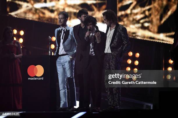 The 1975's Matthew Healy, Adam Hann, George Daniel and Ross MacDonald receive the award for Best British Group on stage at The BRIT Awards 2017 at...