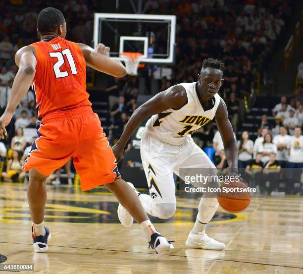 Iowa Hawkeyes' guard Peter Jok tries to dribble azround Illinois guard Malcolm Hill during a Big Ten Conference basketball game between the...