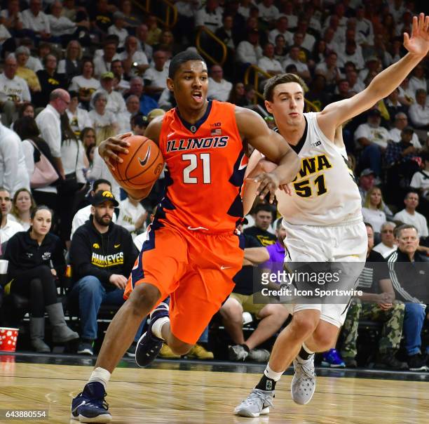 Illinois guard Malcolm Hill gets by Iowa Hawkeyes' forward Nicholas Baer during a Big Ten Conference basketball game between the University of...