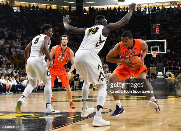 Illinois guard Malcolm Hill looks to get by Iowa Hawkeyes' guard Peter Jok during a Big Ten Conference basketball game between the University of...