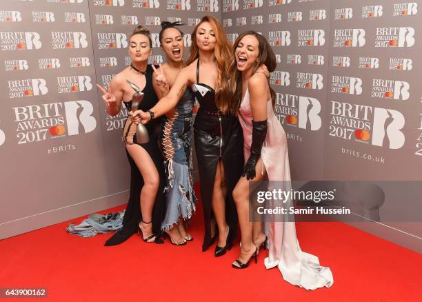 Perrie Edwards, Leigh-Anne Pinnock, Jesy Nelson and Jade Thirlwall of Little Mix pose with their award for Best British Single in the winner's room...