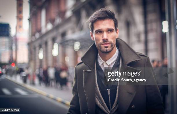 modern man in winter coat - handsome people stock pictures, royalty-free photos & images