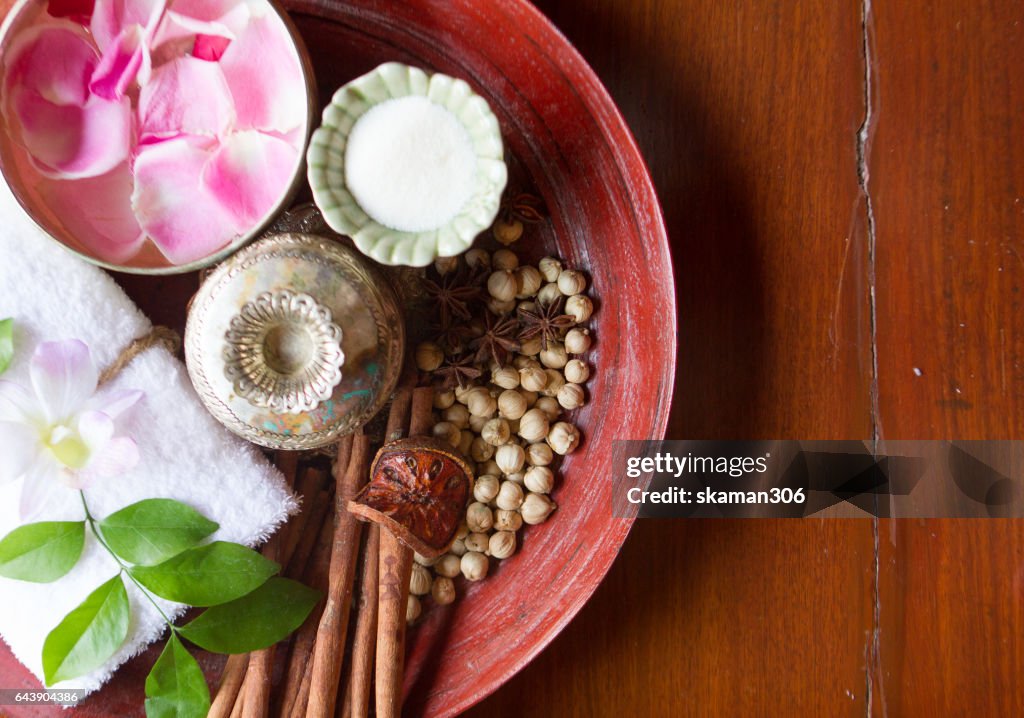 Thai herb and salt with towel on wooden plate ingredient for theraphy