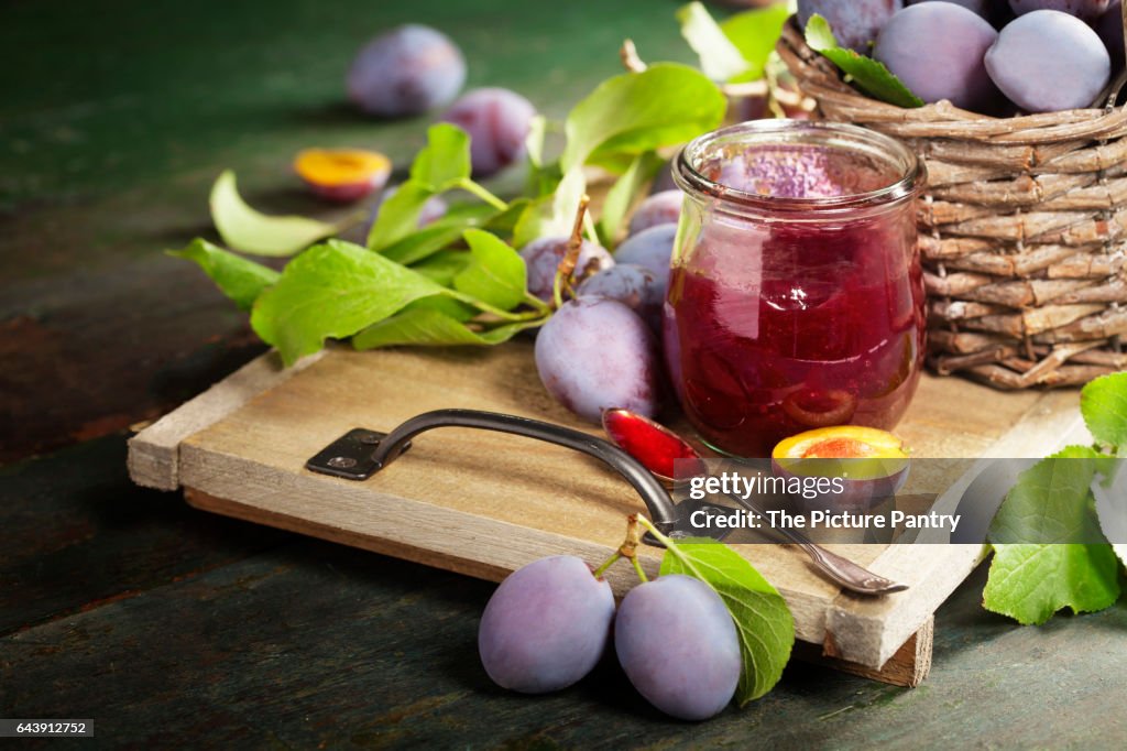 Sweet plums on wooden background. with plum jam.