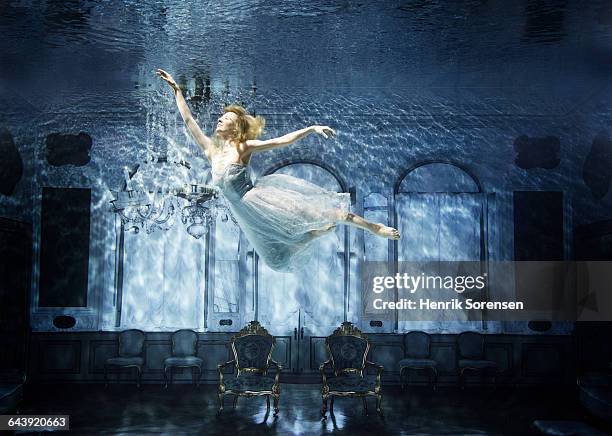 young woman floating gracefully in sunken castle - underwater room stock pictures, royalty-free photos & images