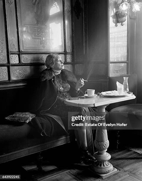 An elegant woman smoking in the Caffè Florian, Venice, Italy, 1977 .