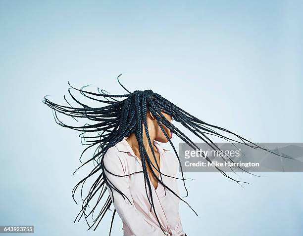 portrait of black female flicking hair - schwarzes haar stock-fotos und bilder