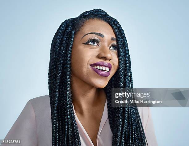 young black female smiling away from - lila lippenstift stock-fotos und bilder