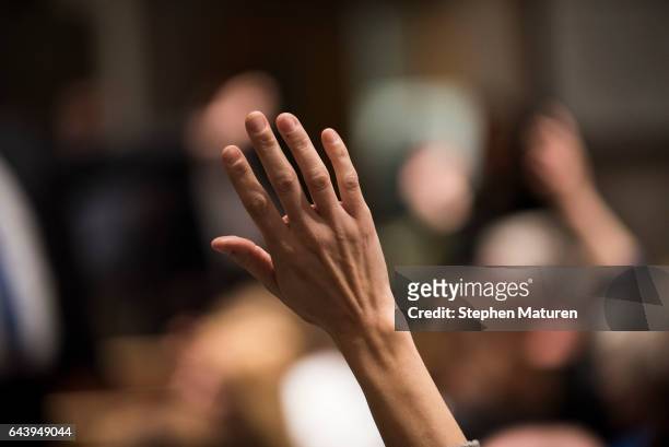 Constituent of Minnesota's 6th District raises their hand to ask a question of Rep Tom Emmer at a town hall meeting on February 22, 2017 in Sartell,...
