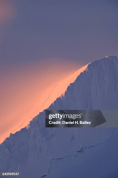 sunset light on a snowy mountain ridge in alaska - alpenglow stock pictures, royalty-free photos & images