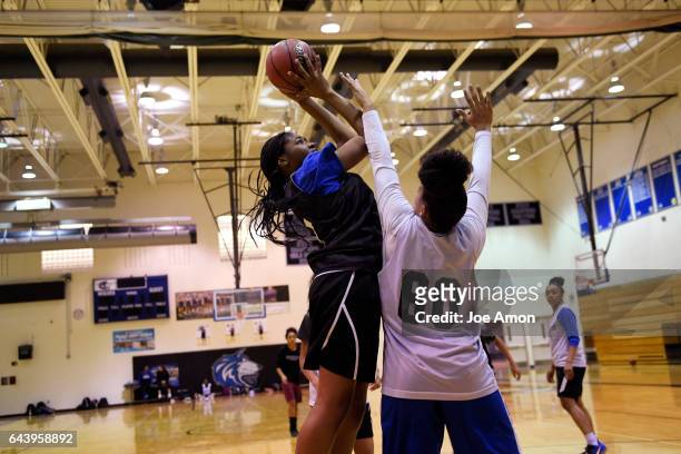 Grandview high school's Alisha Davis shoots over teammate Leilah Vigil during practice at the schools gym. February 22, 2017 Aurora, CO.