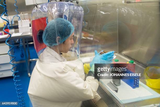Workers are seen inside the P4 laboratory in Wuhan, capital of China's Hubei province, on February 23, 2017. - The P4 epidemiological laboratory was...