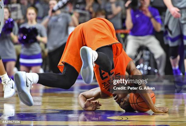 Forward Leyton Hammonds of the Oklahoma State Cowboys tumbles on the floor after chasing down the ball against the Kansas State Wildcats during the...