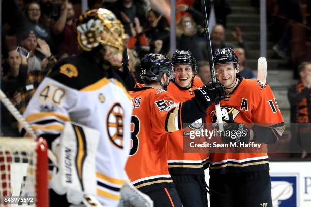 Corey Perry and Nicolas Kerdiles of the Anaheim Ducks congratulate Rickard Rakell of the Anaheim Ducks after he scored a goal as Tuukka Rask of the...