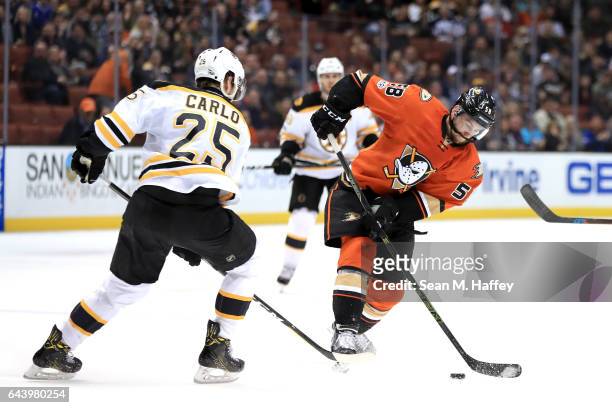Nicolas Kerdiles of the Anaheim Ducks shoots the puck as Brandon Carlo of the Boston Bruins defends during the third period of a game at Honda Center...