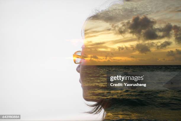 double exposure portrait of a woman with sunset ocean background - portrait double exposure foto e immagini stock