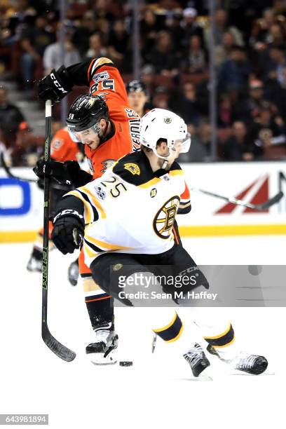Nicolas Kerdiles of the Anaheim Ducks moves around Brandon Carlo of the Boston Bruins during the third period of a game at Honda Center on February...