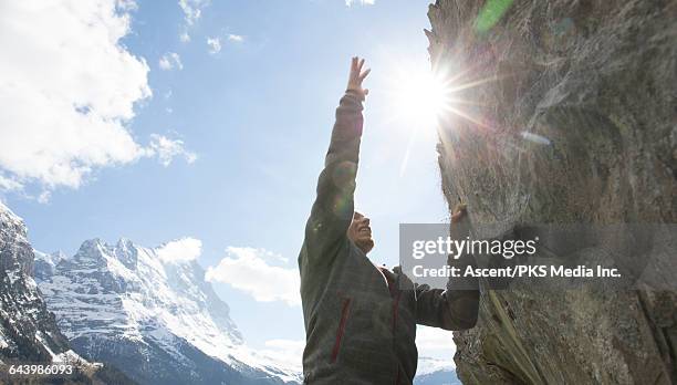 climber reaches for hold on overhanging rock, mtns - grindelwald stock pictures, royalty-free photos & images