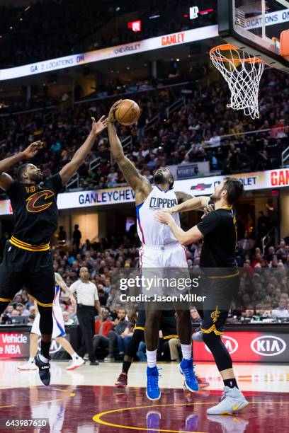 Tristan Thompson and Kevin Love of the Cleveland Cavaliers high for a rebound against DeAndre Jordan of the LA Clippers during the first half at...