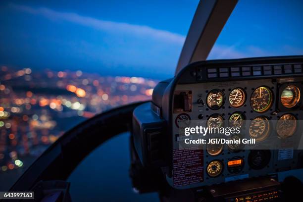 close up of control panel of airplane flying at night - hélicoptère ville photos et images de collection