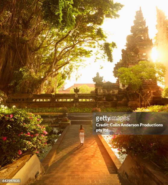 pacific islander woman walking in garden - nusa dua stock pictures, royalty-free photos & images
