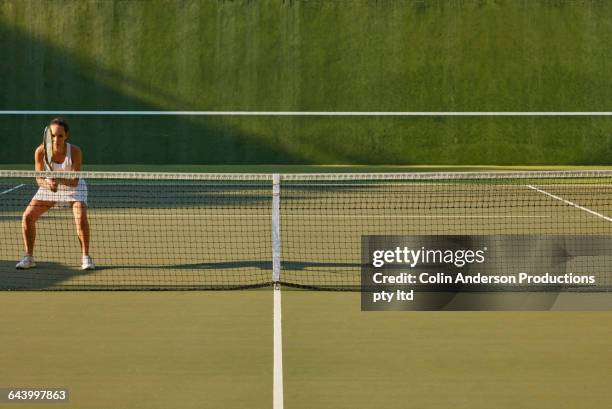 pacific islander woman playing tennis - tennis stock-fotos und bilder