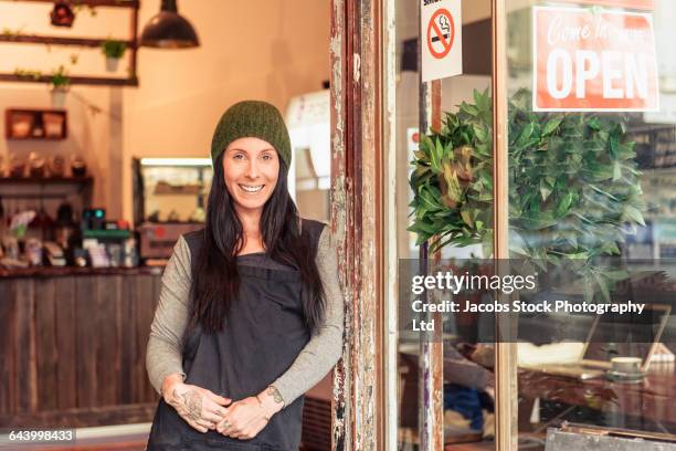 caucasian worker smiling in store doorway - melbourne cafe ストックフォトと画像