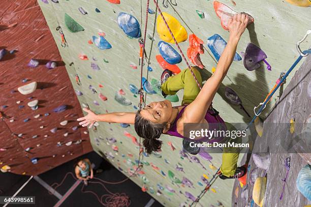 mother belaying daughter climbing rock wall - climbing wall stock pictures, royalty-free photos & images