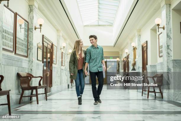 caucasian couple walking in courthouse - young love stock-fotos und bilder