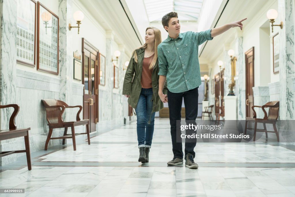 Caucasian couple walking in courthouse