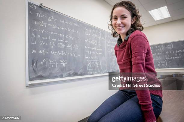 caucasian college student smiling near chalkboard - caldwell idaho - fotografias e filmes do acervo