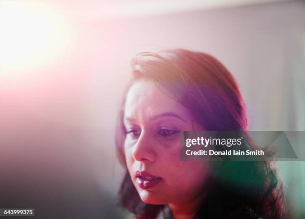 mixed race woman looking down - palmerston stock pictures, royalty-free photos & images